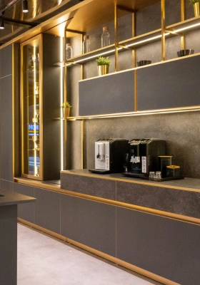 Custom gold-trimmed kitchen cabinetry with built-in coffee station by Mr. Home