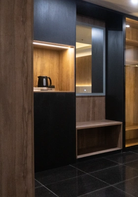 Walk-in dressing room joinery with wood-paneled nook and bench by Mr. Home