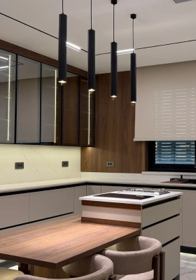 Modern kitchen island with pendant lighting and walnut dining table by Mr. Home